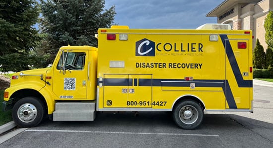 Yellow disaster recovery vehicle parked outside.